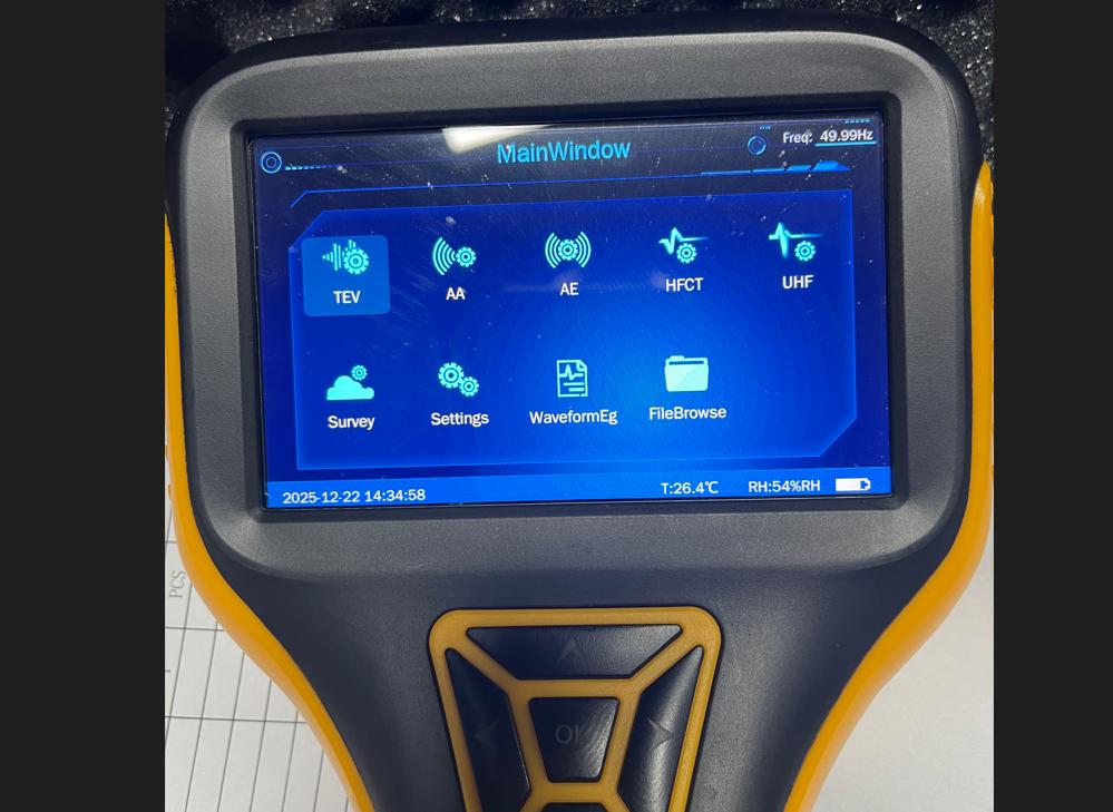 Close-up of a modern handheld partial discharge tester device displaying a clear, user-friendly interface.