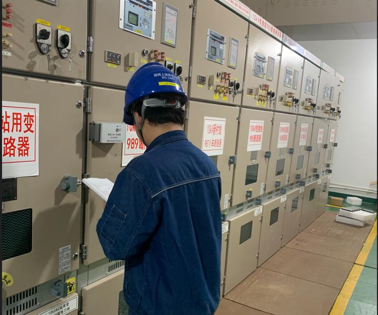Engineer installing partial discharge monitoring sensors on high-voltage switchgear