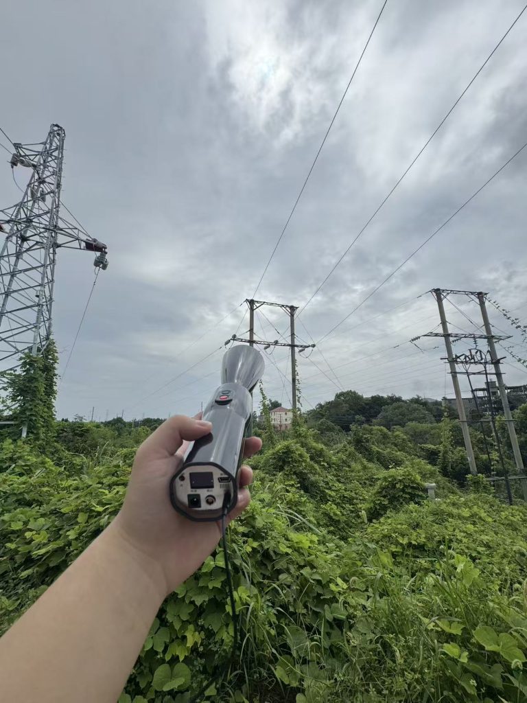 Engineer performing live-line ultrasonic inspection on overhead power line