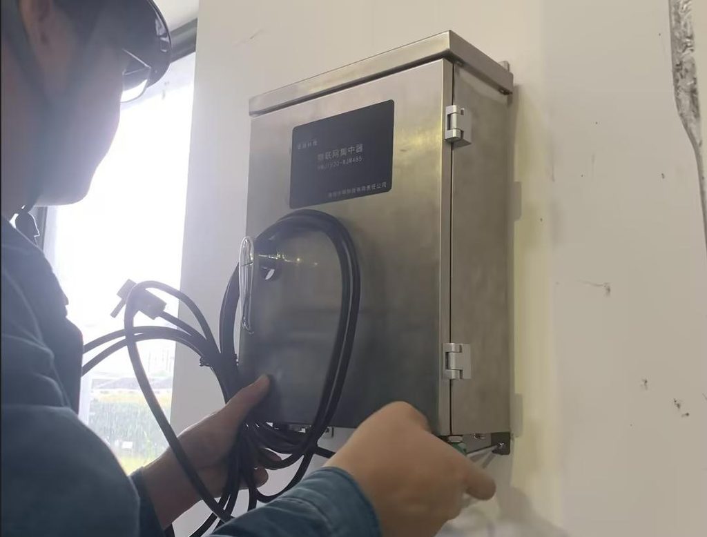 Engineer wiring an IoT data concentrator for 110 kV cable partial discharge monitoring